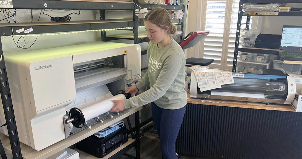 PLACEHOLDER: Emma Richardson working with her Roland BN2-20A desktop print cutter in her home office